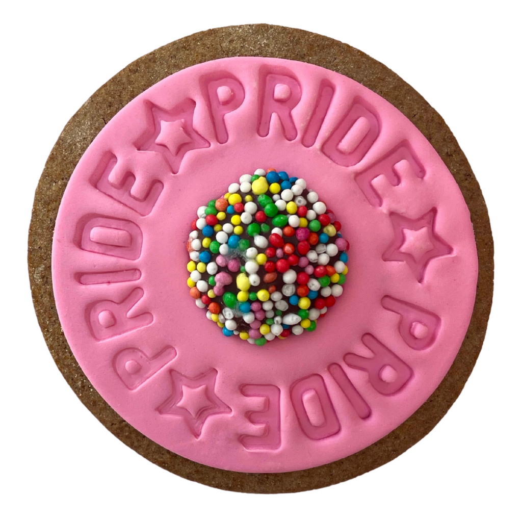 Sweet Mickie Pride Cookie with a Chocolate Freckle, pink icing on a gingerbread cookie