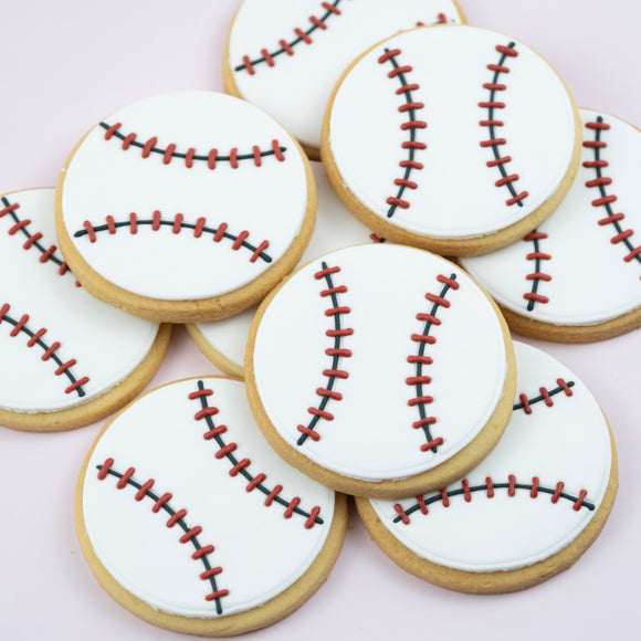 Handcrafted baseball cookies decorated with white fondant and red stitching