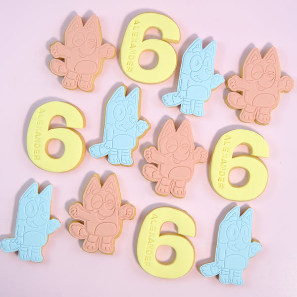 Handmade Bluey-inspired birthday cookies with personalised name, age and colourful fondant character designs