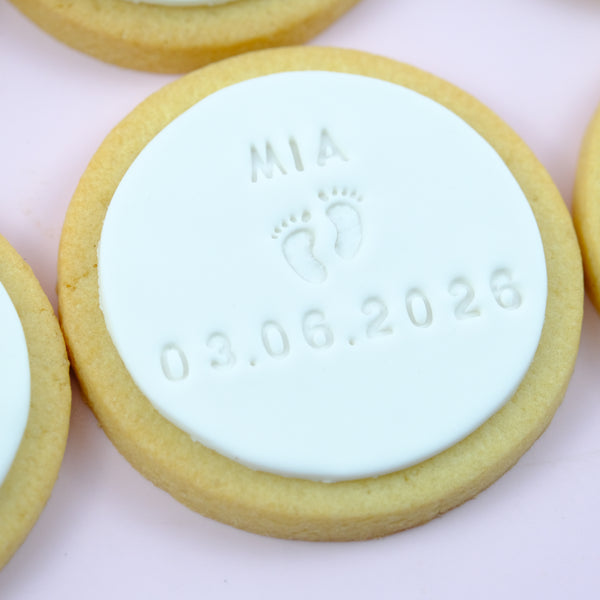 Personalised birth announcement cookies featuring a baby's name, birth date and embossed baby footprints