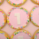 Custom birthday cookies featuring edible photos and pastel fondant numbers
