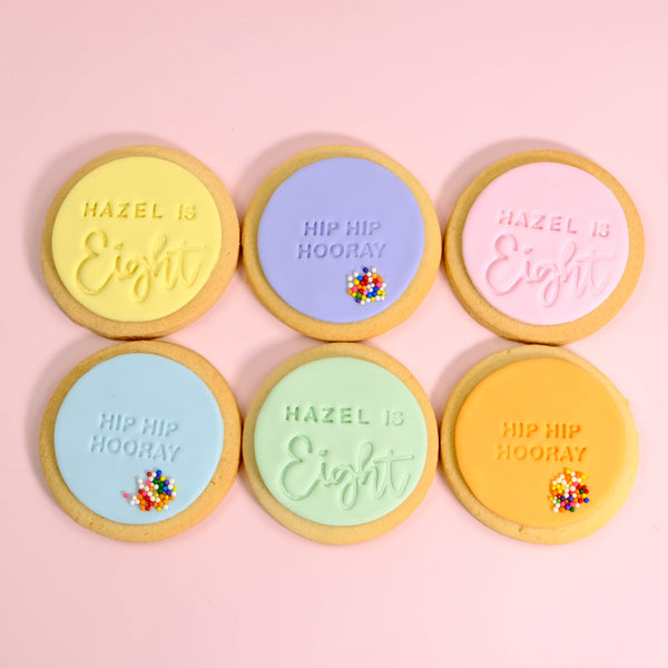 Pastel birthday cookies with custom message and rainbow sprinkles