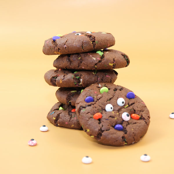 Spooky Monster NY Style Halloween cookies with colourful candy pieces and edible googly eyes.