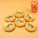 Spooky Spider NY Style Halloween cookies topped with edible chocolate spiders and googly eyes beside a pumpkin decoration