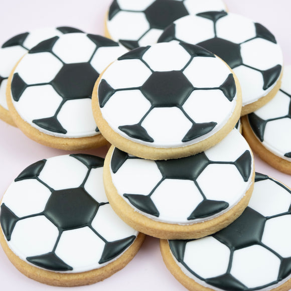 Handcrafted soccer ball cookies decorated with white fondant and black football pattern