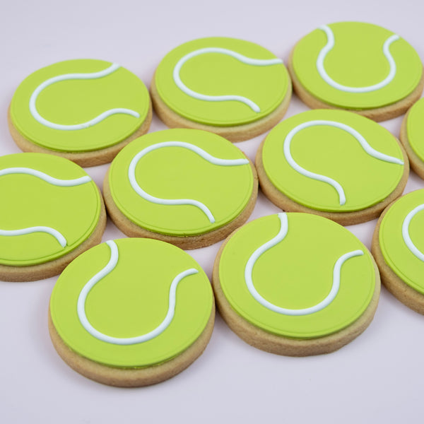 Handcrafted tennis ball cookies decorated with bright green fondant