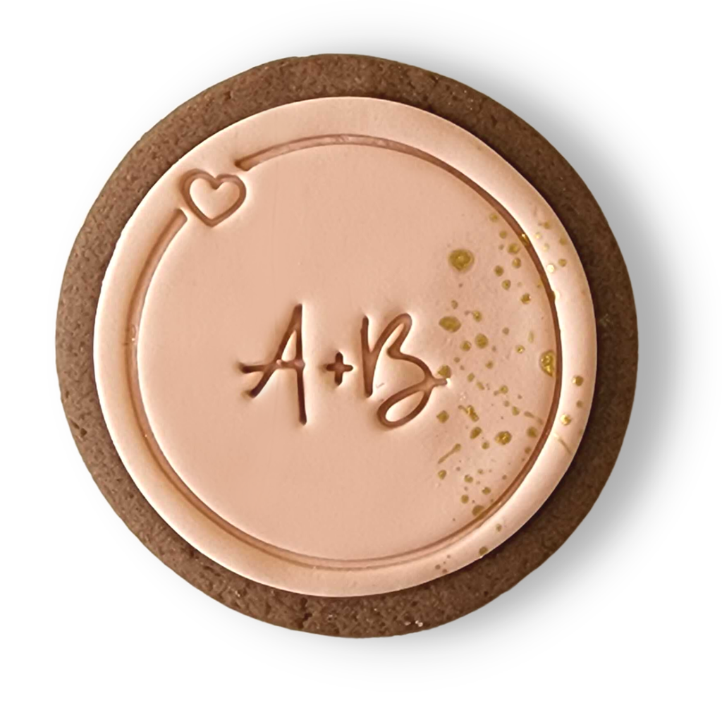 Sweet Mickie wedding cookies with custom initials and gold flecks