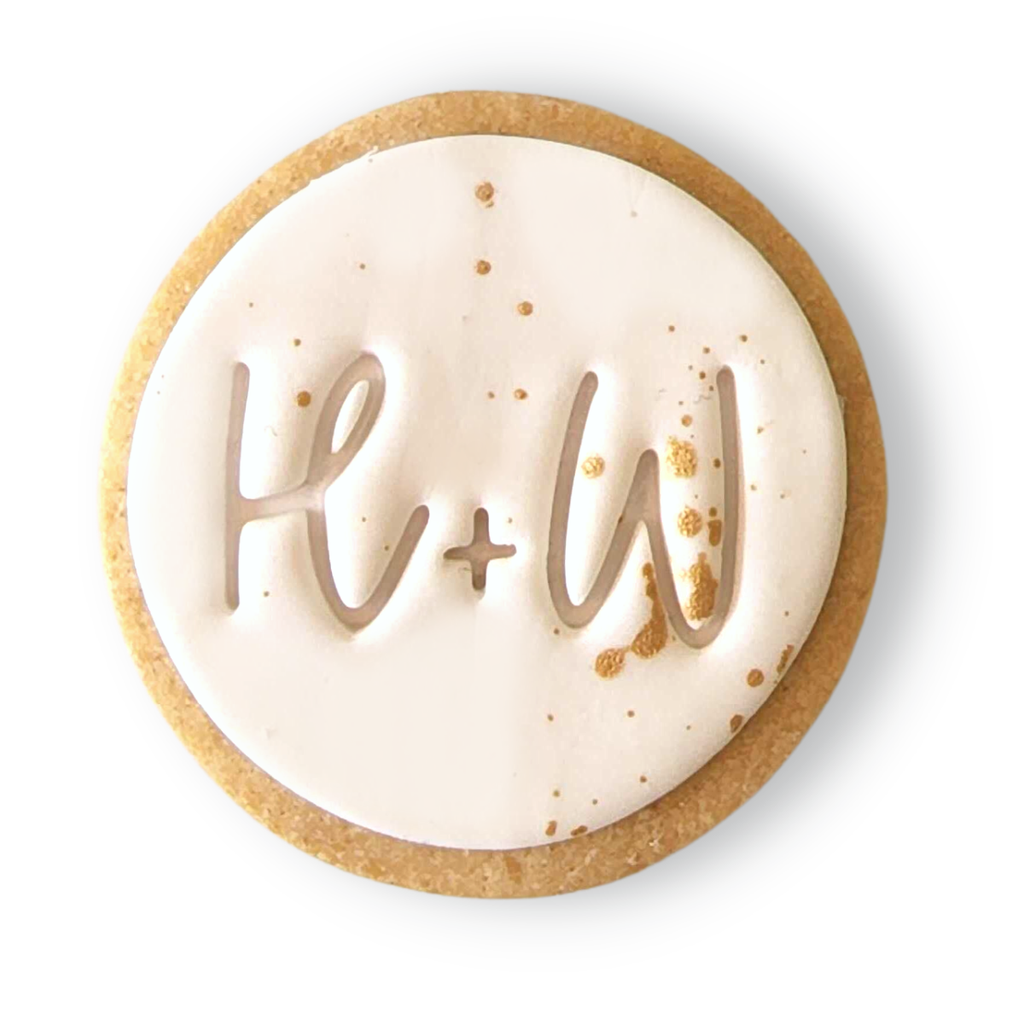 Sweet Mickie wedding cookies with custom initials and gold flecks